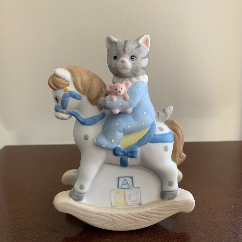 Kitty Cucumber on Rocking Horse